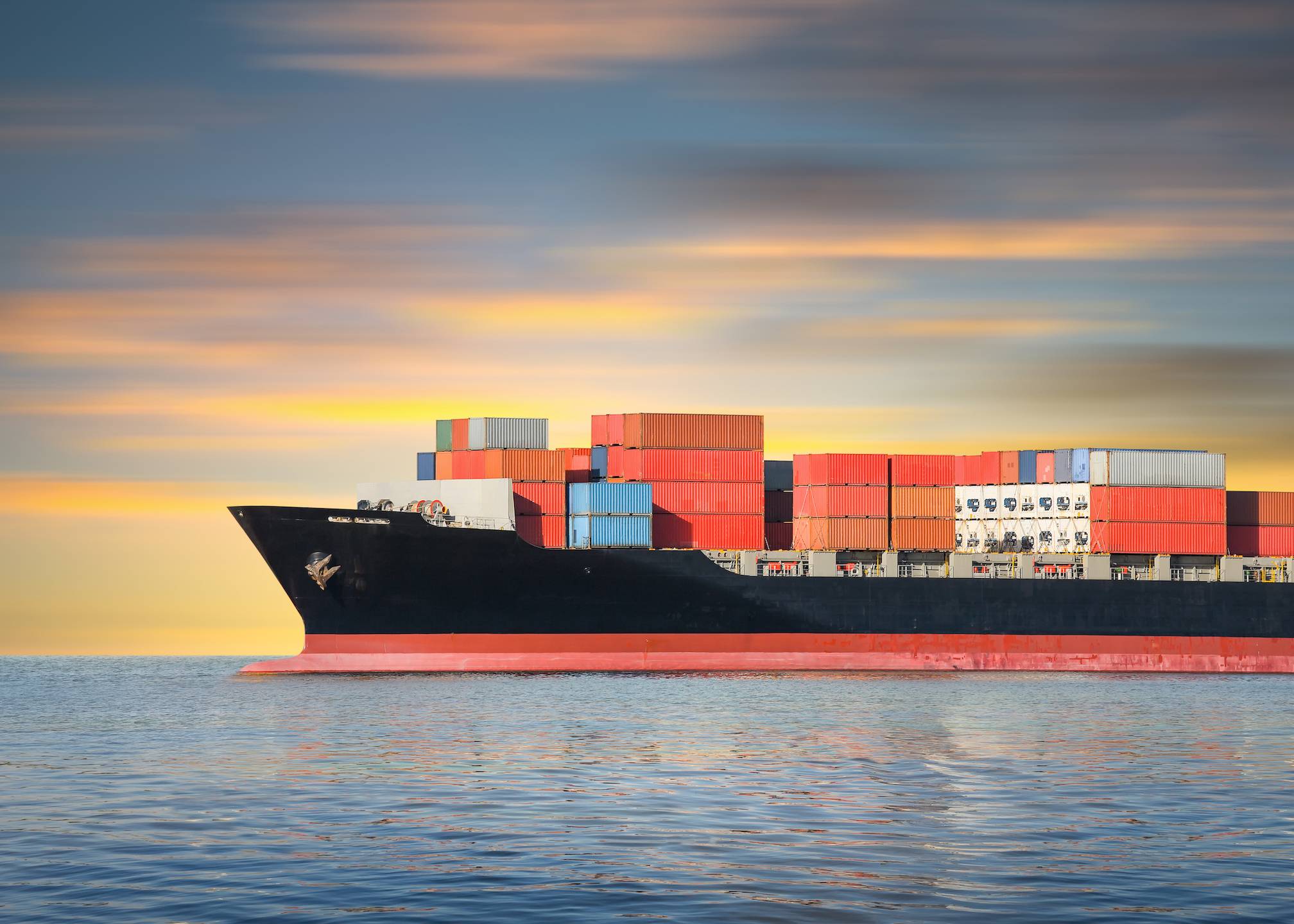 Cargo ship and cargo container in sea with sky background.